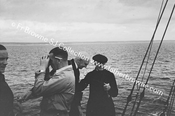 PASSENGERS ON FERRY LOOKING AT COAST